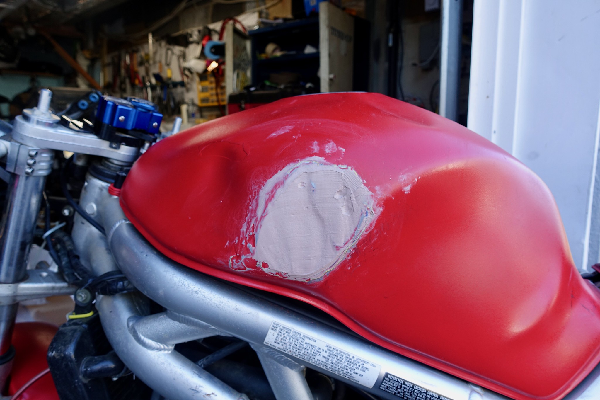 Bondo applied to a dented motorcycle tank