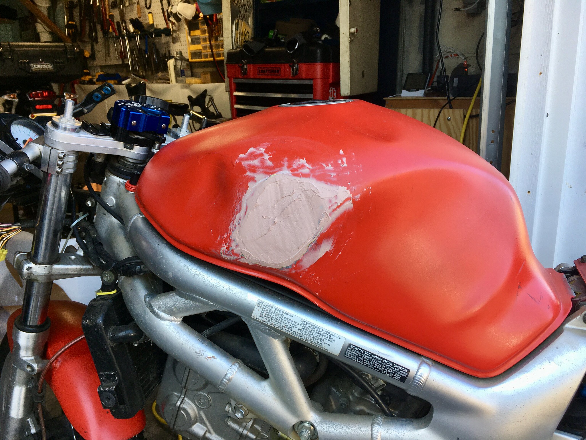 Bondo twice applied to a dented motorcycle tank