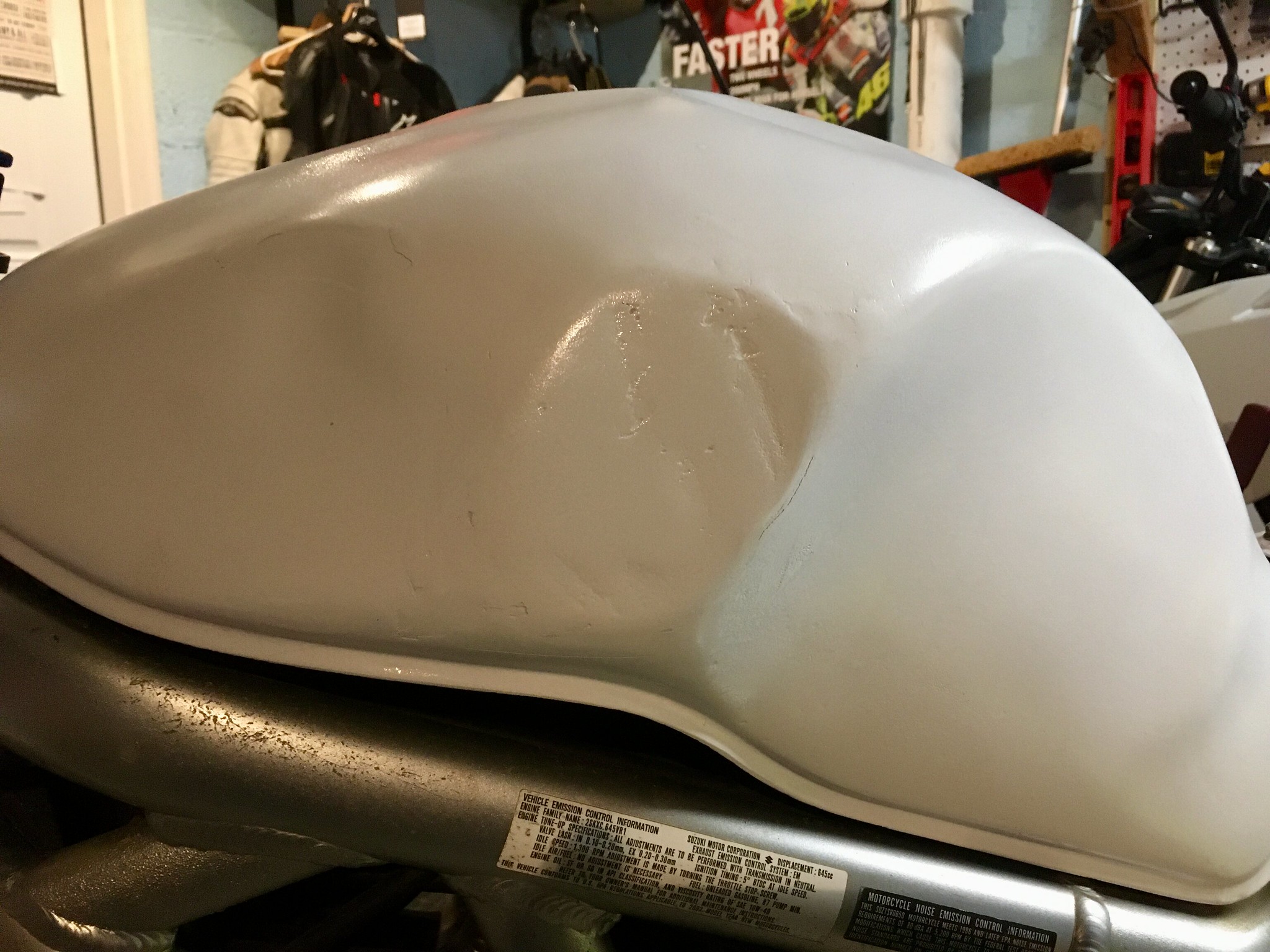 Dented motorcycle tank repaired with Bondo